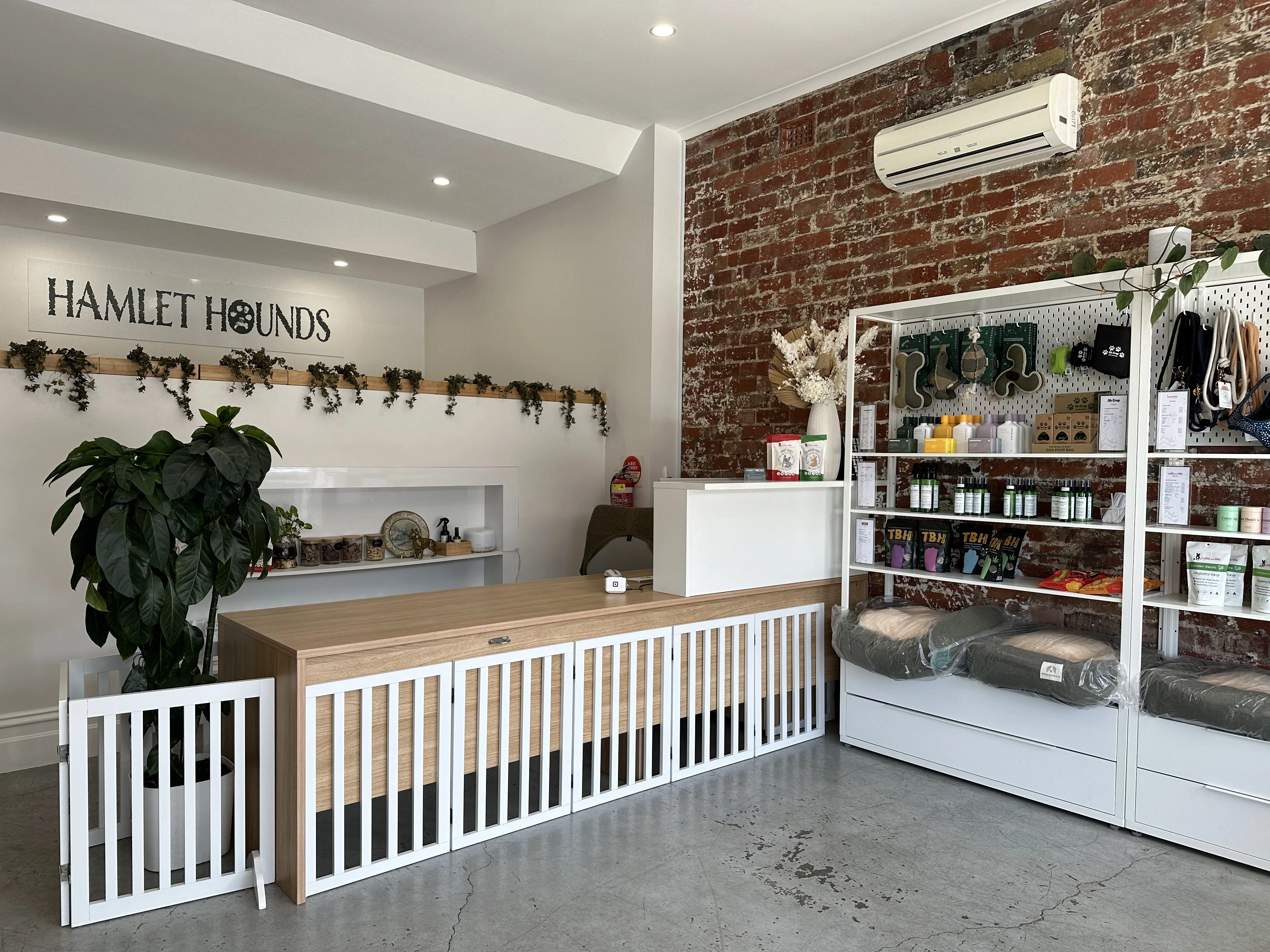 Hamlet Hounds salon interior showing the HAMLET HOUNDS wall sign and product shelving